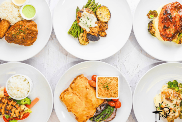 Multiple plates of food on white plates lined up neatly in two rows. A variety of proteins and veg
